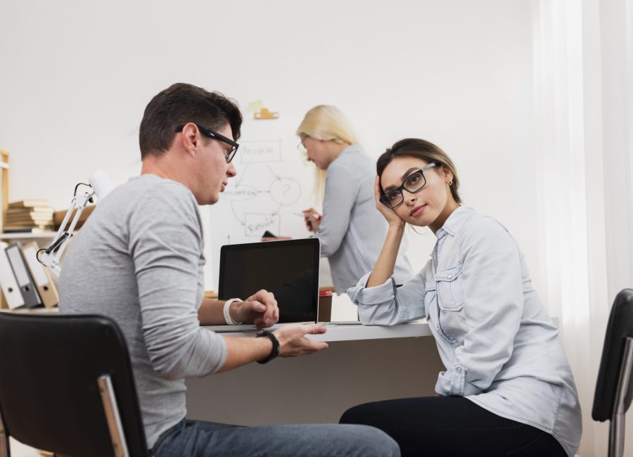 thinking-woman-talking-with-man-office